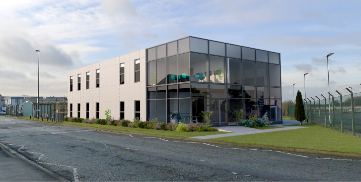 Two-story modern glass office building with reflective windows, positioned at a street corner, surrounded by neatly trimmed grass and shrubs. Late afternoon or early morning sky with soft clouds.